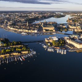 a large body of water with a city in the background