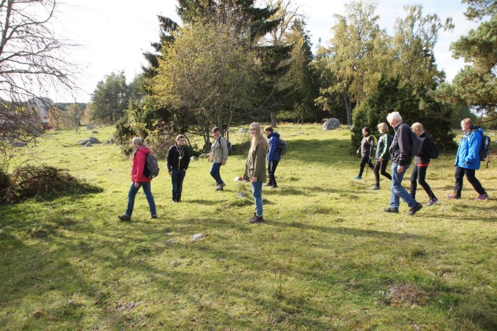 a group of people walking in a fiield