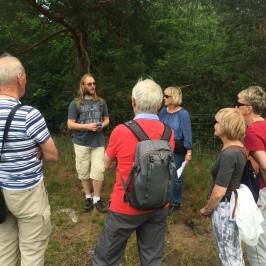 a group of people standing in the grass