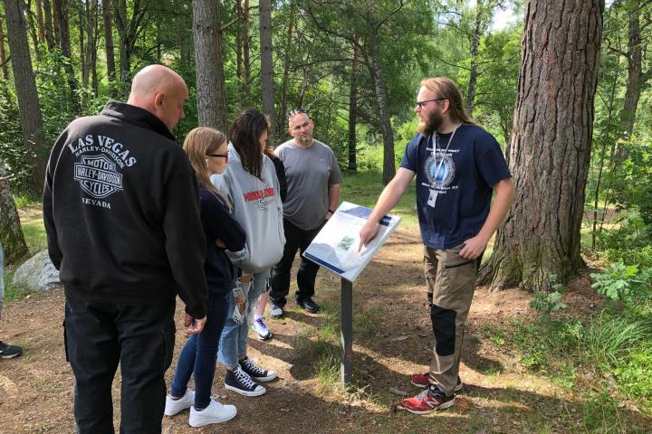 a group of people standing next to a tree