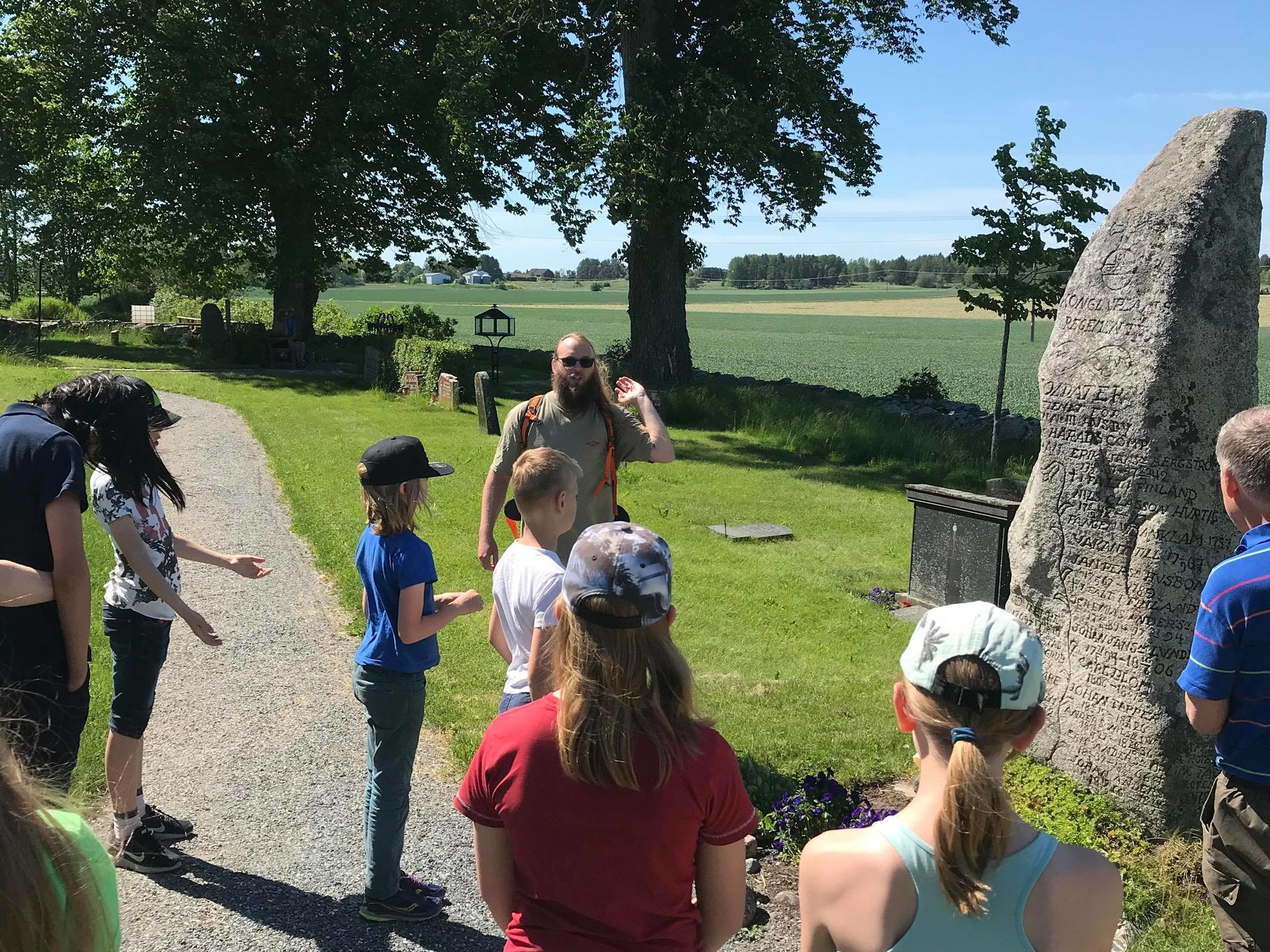 a group of people that are standing in the grass