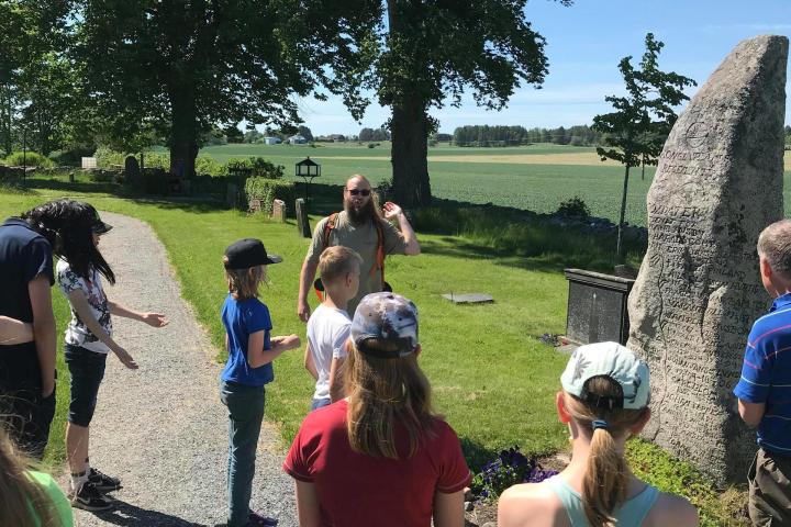 a group of people that are standing in the grass