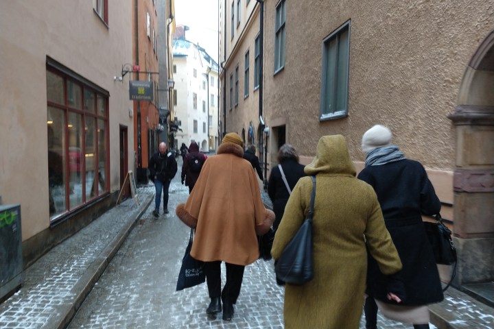 a group of people walking down a city street