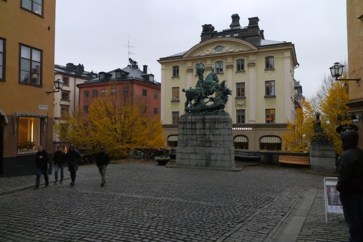 a group of people walking in front of a building