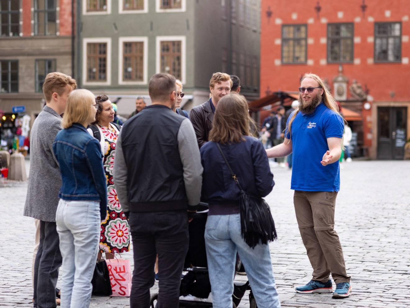 a group of people standing on a sidewalk