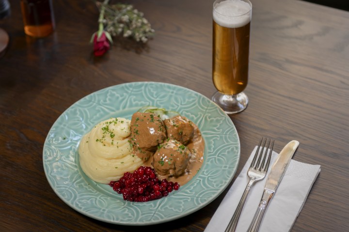 a plate of food sitting on top of a wooden table
