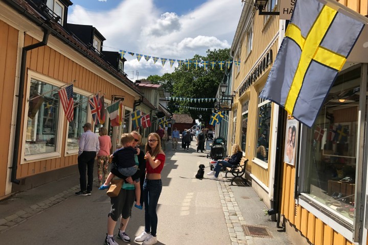 a group of people walking on a city street