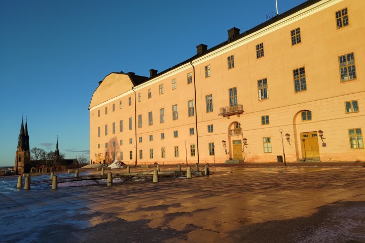a castle with a clock tower in front of a building