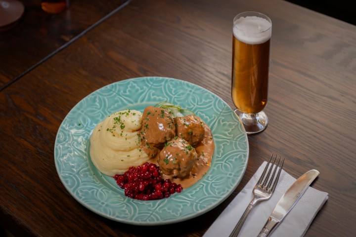a plate of food sitting on top of a wooden table
