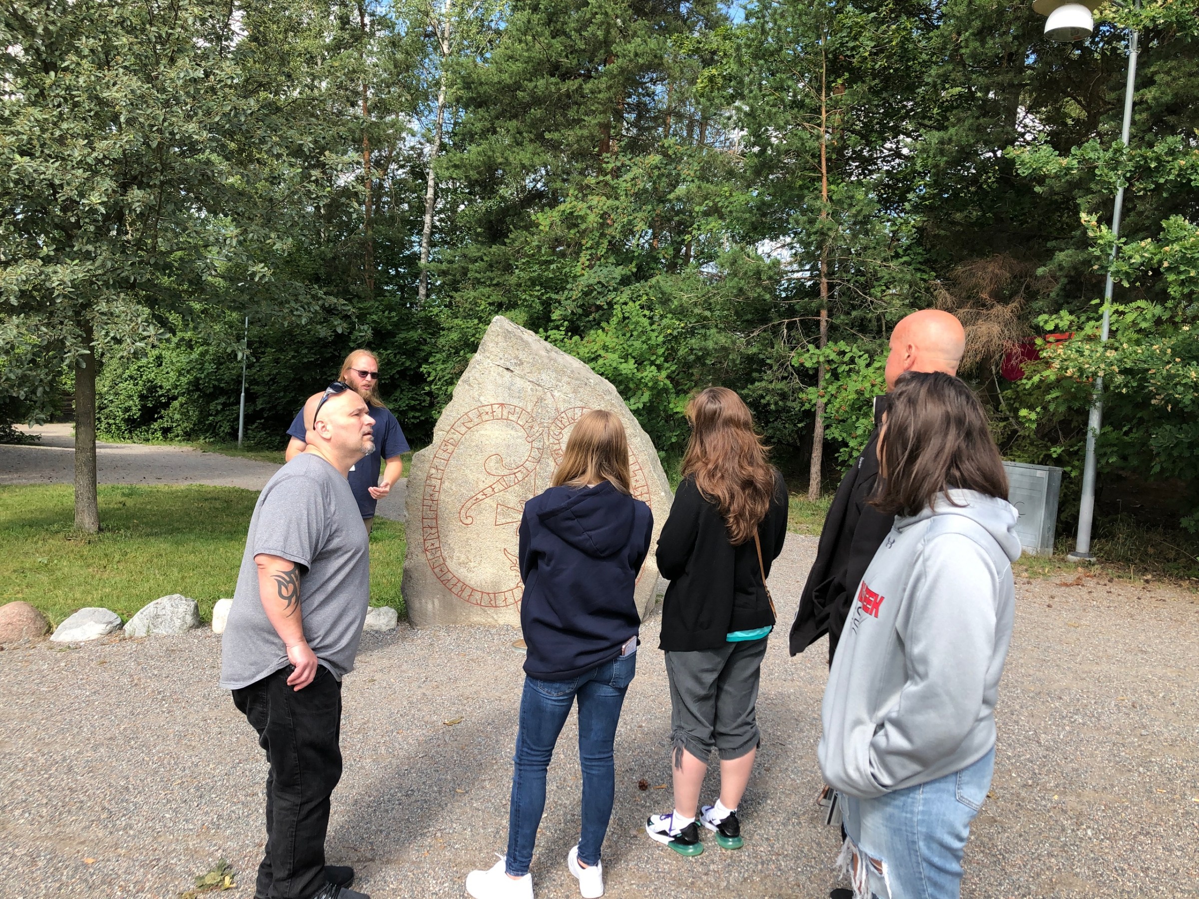 a group of people standing next to a tree